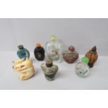 Seven Oriental design perfume bottles, one glass decorated with a tiger amongst foliage with