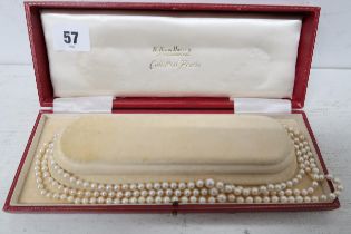 A string of cultured pearls with a silver clasp - boxed