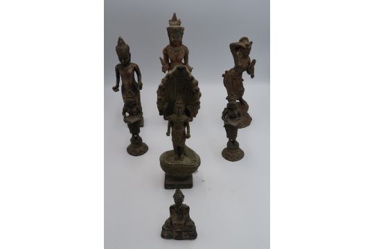 A group of Indo-Chinese deity figures including dancing apsara, a metal statue of a Khmer standing