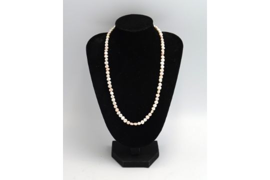 A freshwater pearl necklace. Clasp stamped 9K. Weight 13.78 grams