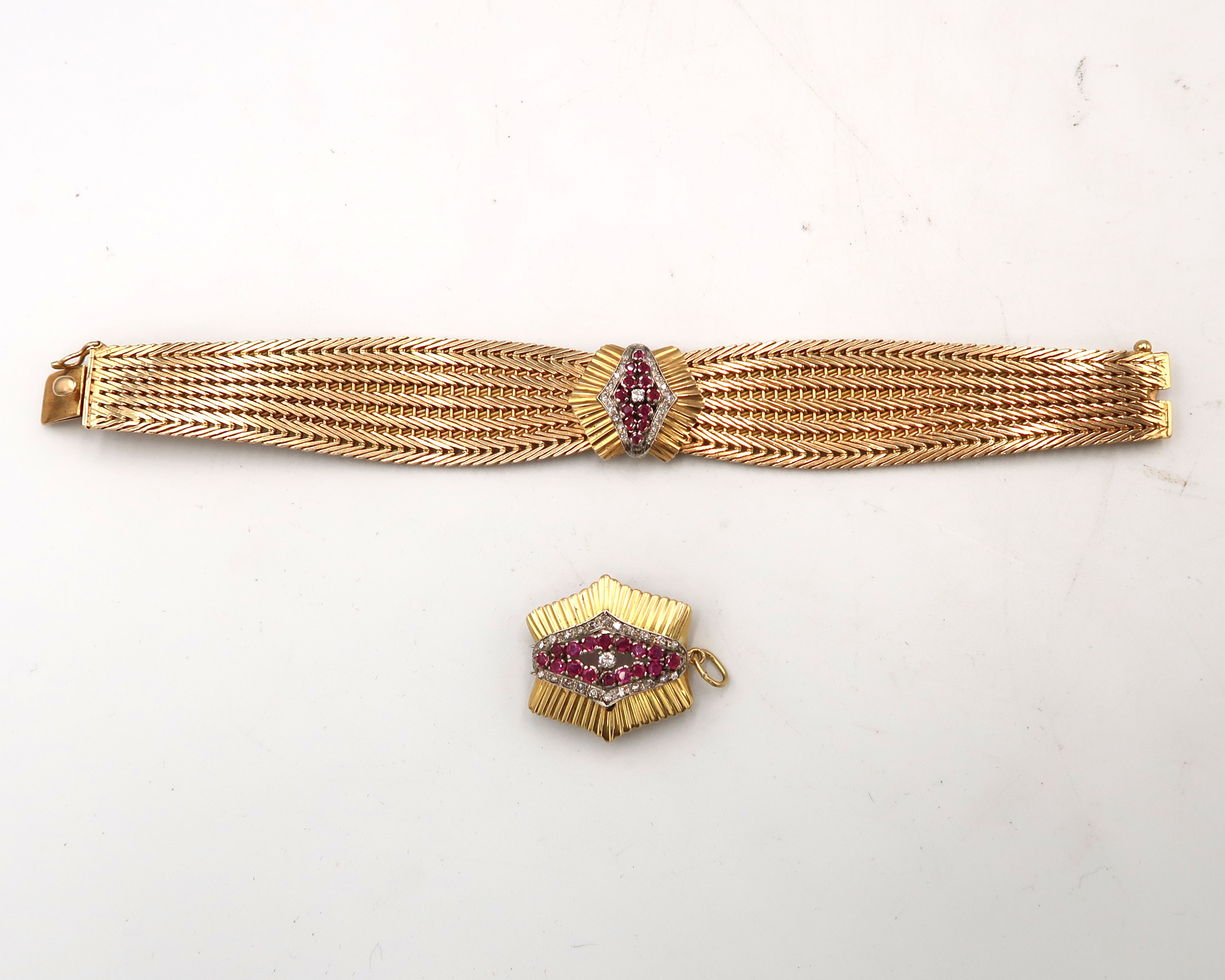 A 750 18ct marked Art Deco style tapered woven bracelet with central ruby and diamond cluster.