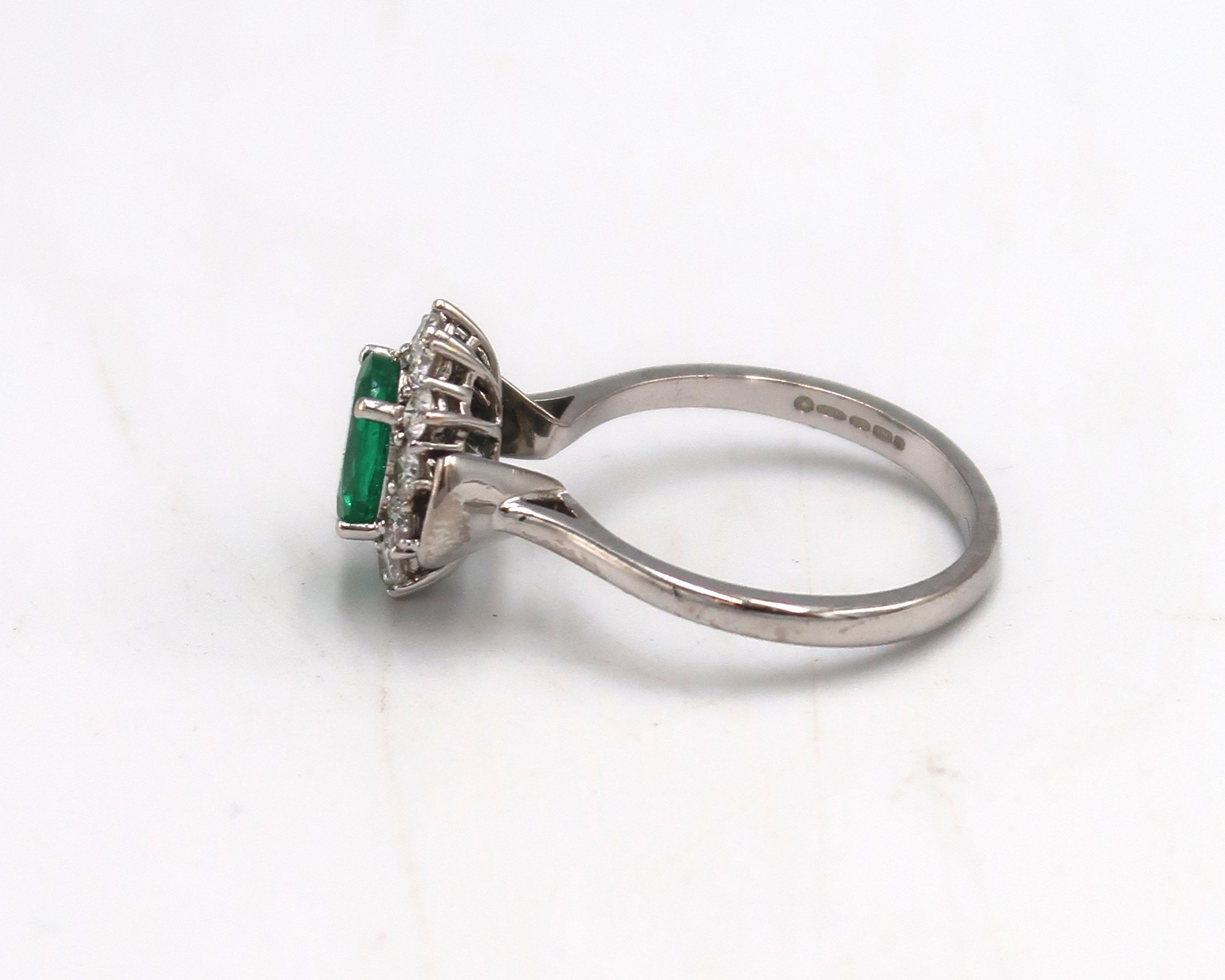 A 18ct White gold Dress ring. approx. 1.5ct emerald surrounded by 12 brilliant cut diamonds Size P - Image 2 of 3