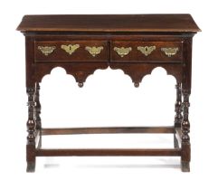 A GEORGE I WELSH OAK SIDE TABLE VALE OF GLAMORGAN, C.1720 the moulded edged top above a pair of