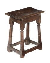 A CHARLES II OAK JOINT STOOL LATE 17TH CENTURY the seat with a moulded edge above ring turned legs