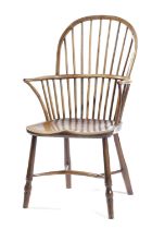A YEW AND ELM STICK BACK WINDSOR ARMCHAIR EARLY 19TH CENTURY with a saddle seat and turned legs,
