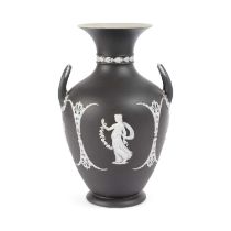 A WEDGWOOD BLACK JASPERWARE VASE C.1900 applied in white with classical maidens between formal