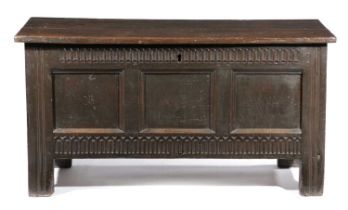 A LARGE OAK COFFER POSSIBLY WELSH, MID 17TH CENTURY the boarded top with wooden hinges, revealing