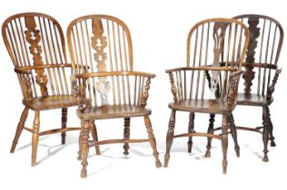 A HARLEQUIN SET OF FOUR HIGHBACK WINDSOR ARMCHAIRS 19TH CENTURY two in ash and two in yew, each with