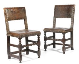 TWO OAK BACK STOOLS LATE 17TH CENTURY each with a brass studded leather back and seat, one with a