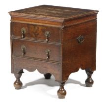 A GEORGE I OAK CLOSE STOOL EARLY 18TH CENTURY with a hinged top above a false drawer front, with