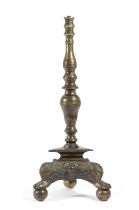 A DUTCH BRASS ALTAR CANDLESTICK POSSIBLY 17TH CENTURY the turned stem on a triangular base with