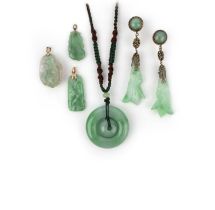 A group of jadeite jewels, comprising: a pair of earrings, length 8.9cm each; and four pendants,