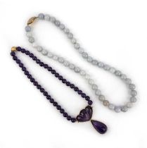Two necklaces, one composed of pale green and lavender jadeite beads, to a gold clasp, length
