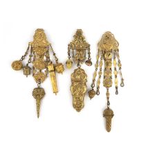 Three chatelaines, 19th century, each designed in the Rococo revival style in gilt metal, suspending