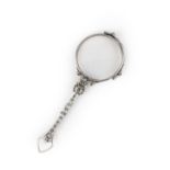 A diamond lorgnette, early 20th century, designed as a spring-loaded pair of circular eyeglasses,