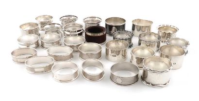 A collection of twenty-six silver napkin rings, various dates and makers, including: an unmarked