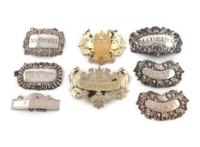 A collection of eight silver and unmarked wine labels, including: a pair by Hilliard and Thomason,