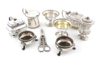 A collection of antique silver condiments, comprising: a pair of George III salt cellars,