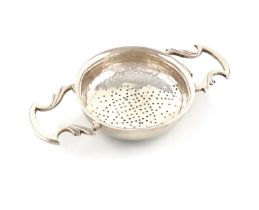 A George II silver lemon strainer, by Charles Chesterman, London 1751, circular form, scroll side