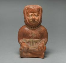 A Moche stirrup spout figure vessel Peru, circa 300 - 500 AD pottery, the crossed legged seated