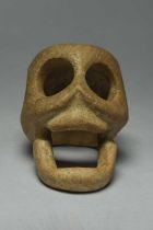 A Veracruz stone carving of a stylised skull Mexico, circa 500 - 900 AD 10cm long, 6.5cm high.