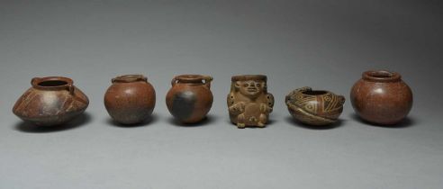 Six Colombian vessels circa 800 - 1200 AD and later pottery, including a squatting male figure, 8.