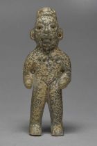 An Olmec style stone standing figure with pierced ears and chest, 16cm high.