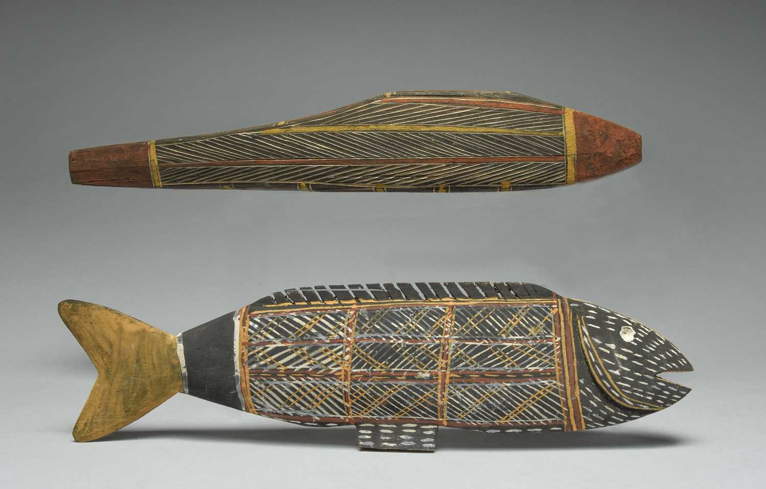 Two Tiwi model fish Australia one with incised linear decoration and both with pigment, 41cm and