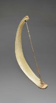 An Inuit whalebone fire drill bow Arctic with sinew, 43.5cm long.