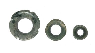 A Maya ear ornament Mexico, circa 300 - 500 AD greenstone, of three graduated circular rings with