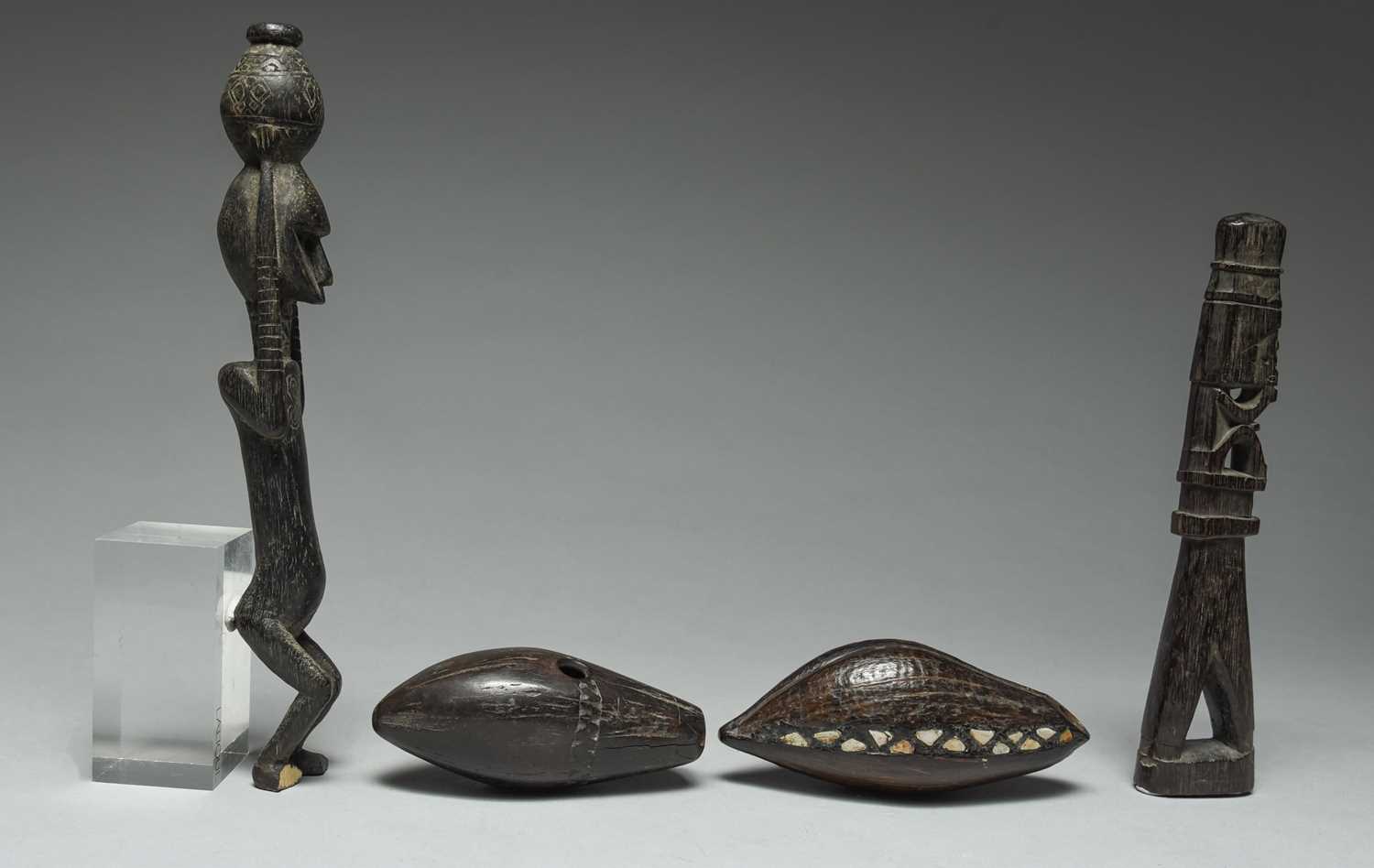 A Korwar float / charm Irian Jaya, Indonesia carved with a seated figure and with an open base, - Image 3 of 4