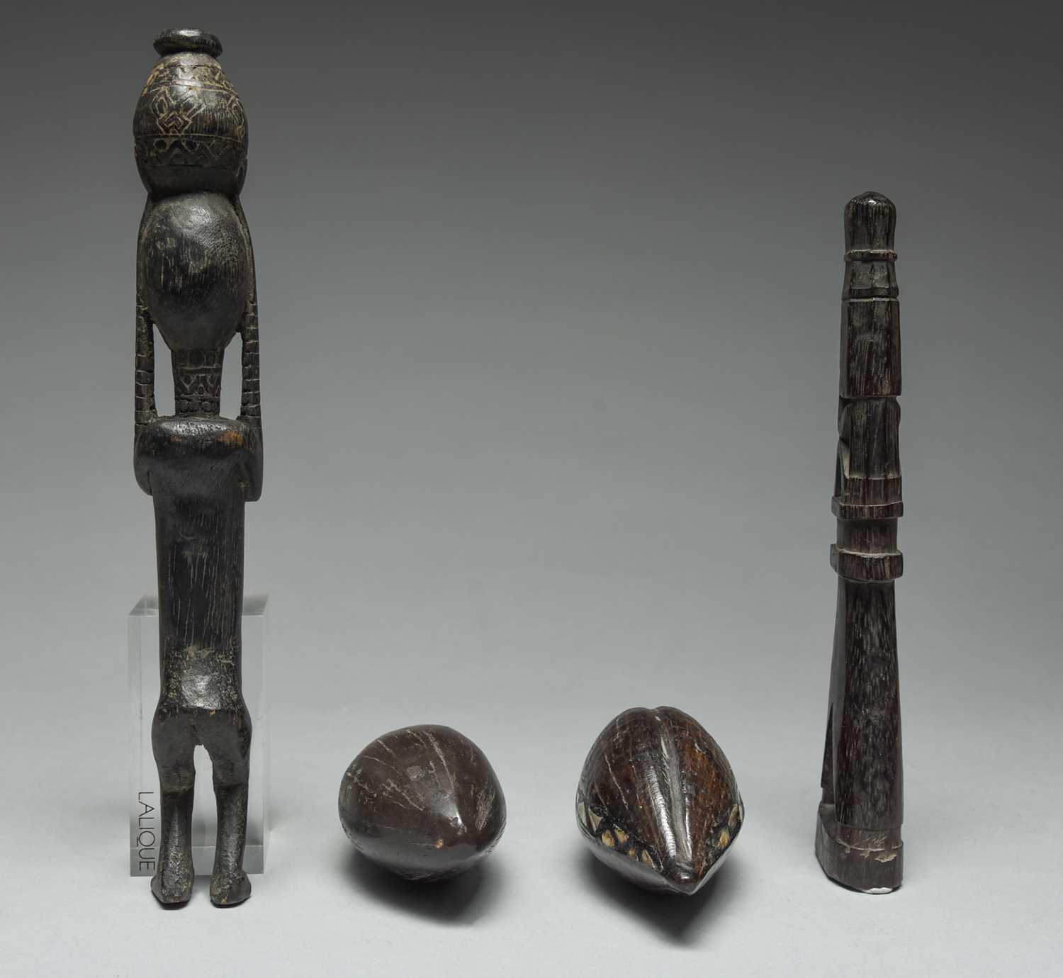A Korwar float / charm Irian Jaya, Indonesia carved with a seated figure and with an open base, - Image 4 of 4