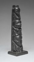 A Haida model totem pole British Columbia argillite, carved a raven, beaver and a whale, the base