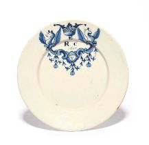 A Delft marriage plate, dated 1690, painted in blue with two winged griffins flanking a cartouche