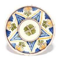 A London delftware charger, c.1660-80, painted in blue, green, manganese, yellow and red with a
