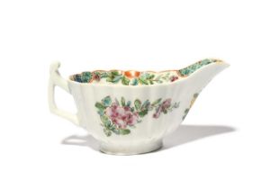 A rare and early Worcester creamboat, c.1750-53, of simple fluted form with an angular handle, the