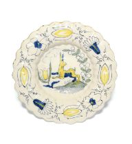 A Delft lobed dish or charger, c.1700, painted in blue, yellow and green with a running dog with