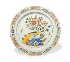 A Bristol delftware charger, c.1740, brightly painted in red, yellow, blue and green with a