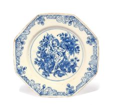 A delftware octagonal plate, c.1740-60, painted in blue with a bewigged putto or Cupid holding a