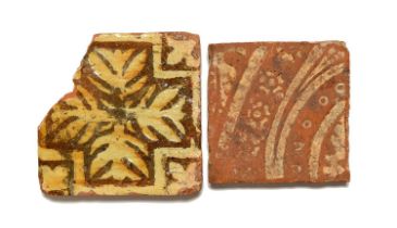 Two medieval encaustic paving tiles, c.14th/15th century, one decorated in cream slip with a