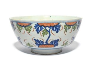 A large delftware bowl, c.1725, probably London, boldly painted in red, blue and green with a