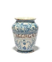 A small North Italian maiolica drug or pill jar, dated 1724, painted in blue with flower and foliate