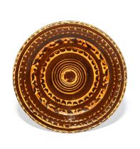 A large slipware charger or serving dish, early 19th century, the circular form decorated in cream