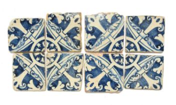 Eight Portuguese faïence tiles, 17th century, painted in blue with foliate and fleur de lys motifs