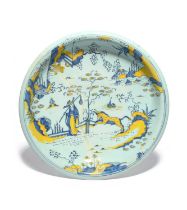 A large delftware charger, c.1700, possibly Bristol, painted in blue and yellow with a Chinese