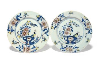 A pair of Bristol delftware plates, c.1760, painted in blue, manganese and yellow with a peacock