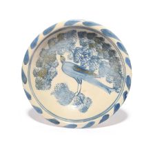 A rare small delftware dish, c.1695, London or Bristol, painted in blue and ochre with a bird