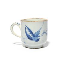 A delftware coffee cup, c.1760, probably Liverpool, painted in blue with a long-tailed bird