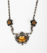 A silver and citrine necklace possibly Australian, the simple drop with foliate border and central