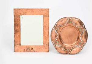 A Jugendstil copper and brass wall mirror, rectangular with stud decoration, set with brass panel